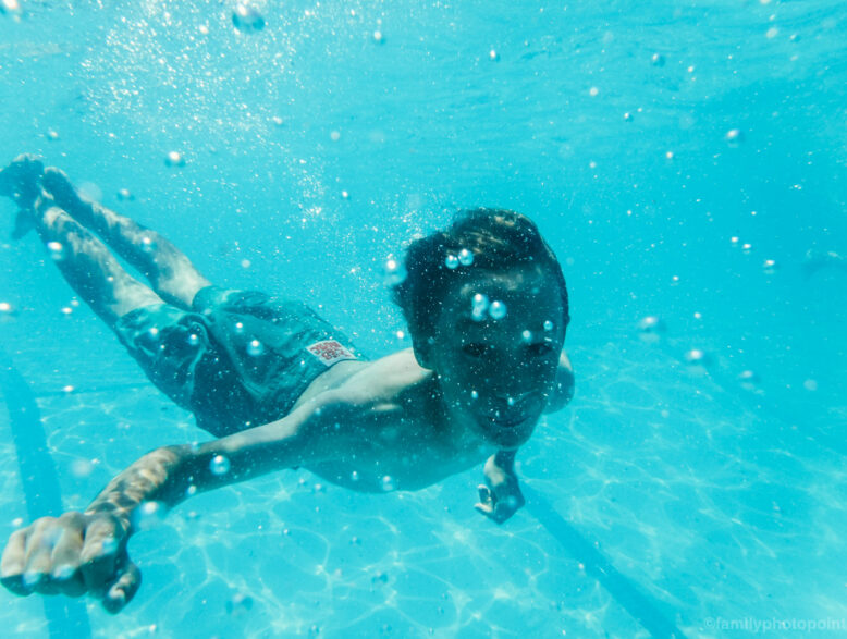 boy swimming underwater.