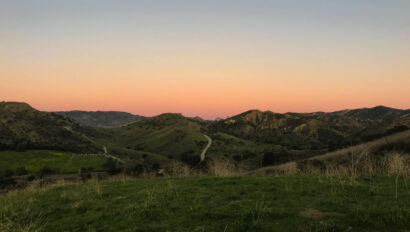 sunset over rolling hills.