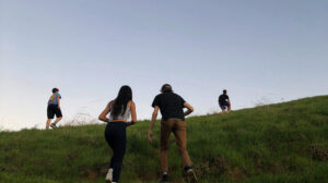teens walking away up a hill.