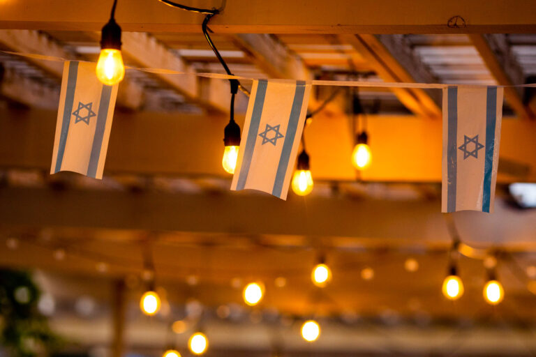 israeli flags strung across a ceiling.