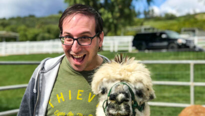 smiling man with a llama.
