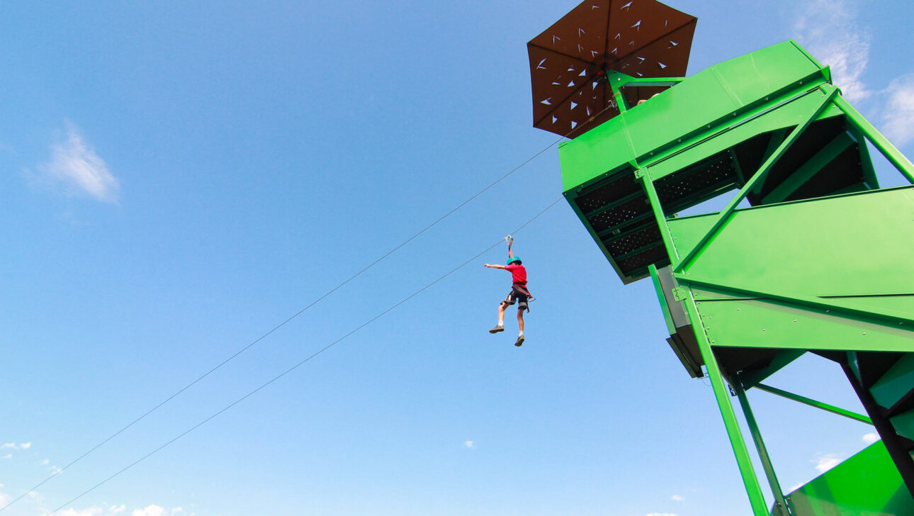 person jumping off a zipline tower.
